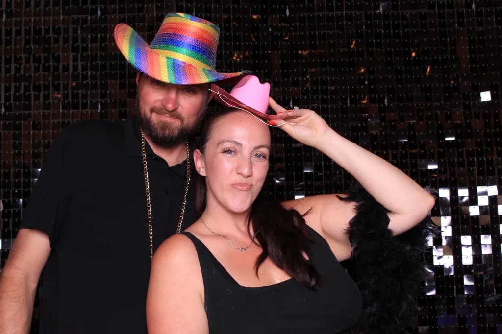 Keshley Roundy and Ben Mitchell of Proof Of Party posing with party props